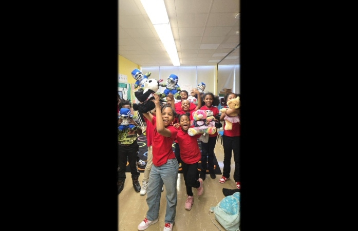  Students holding up the Build A Bear